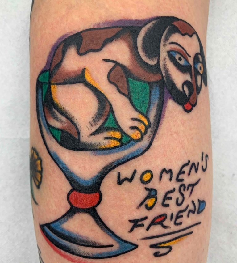 Traditional tattoo Berlin – Tattoos by Mariano – a dog in a martini glass with the saying "Women's Best Friend."