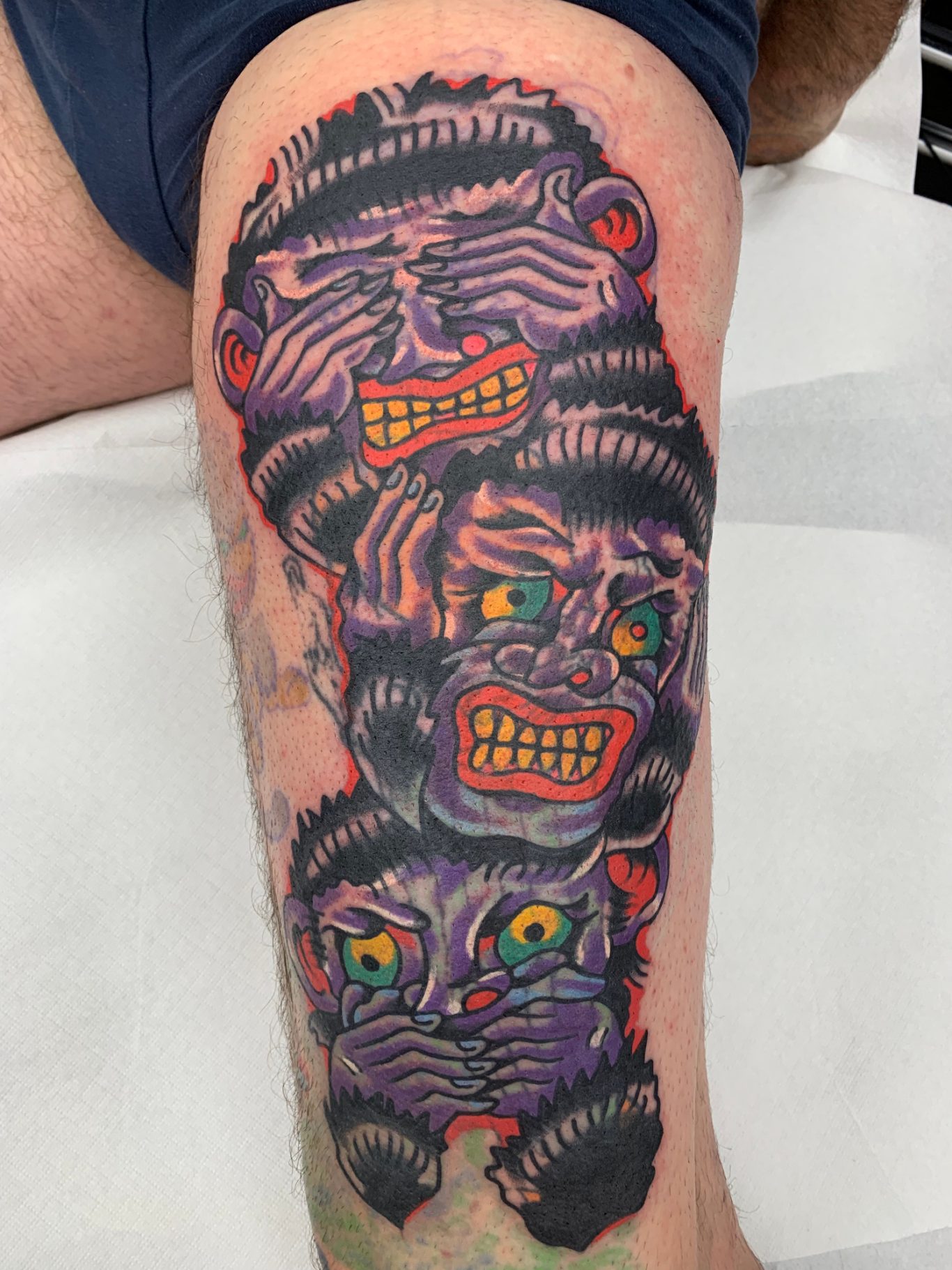 COVER-UP MONKEYS Traditional Tattoo Berlin - Tattoos by Mariano - Cover-up Bunte Tätowierung mit mehreren grimmigen Gesichtern und herausstarrenden Augen.